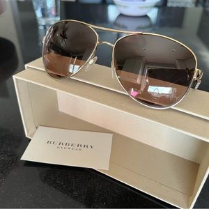 Burberry pilot gold steel sunglasses with light brown lenses.